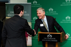 Professor Amato shaking hands with student