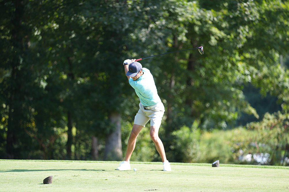 Golfer teeing off 