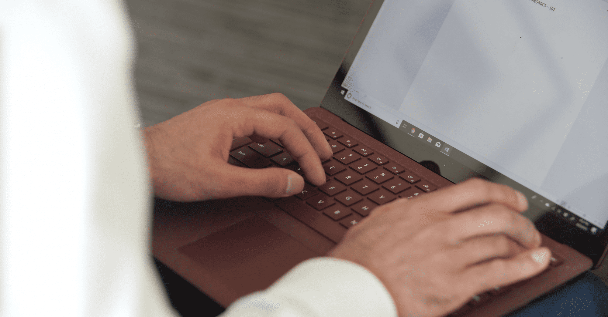 Student typing on laptop