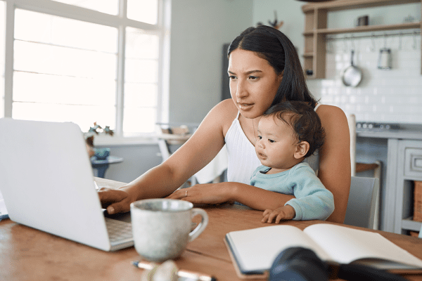 Young mother and child sitting at laptop