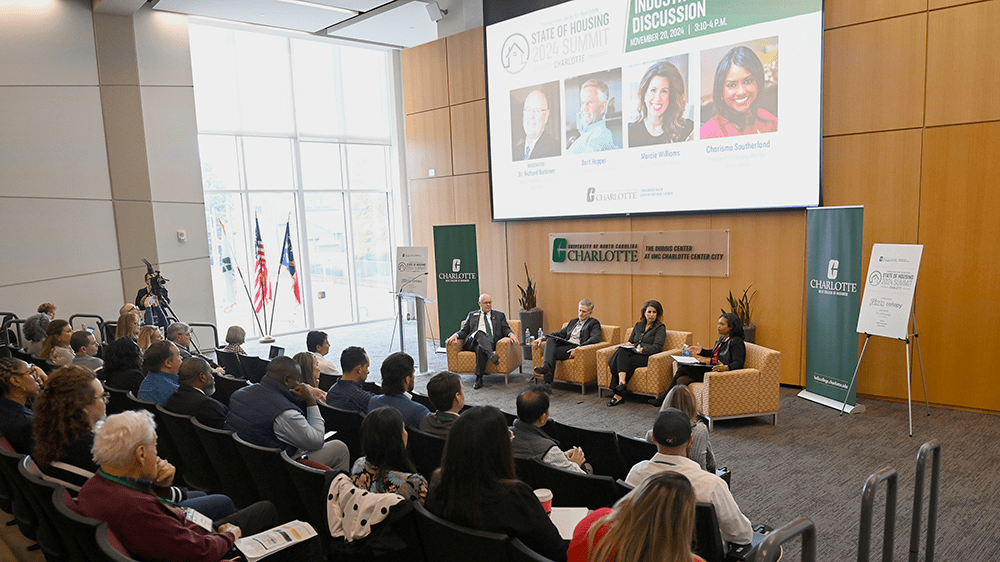 A conversation with industry experts followed Chu’s talk, moderated by Belk College of Business Dean Richard Buttimer, with Charisma Southerland ’94, the 2024 president of Canopy Realtor® Association and Canopy MLS; Bart Hopper, founder and CEO of Hopper Communities, a leader in residential homebuilding and land development; and Marcie Williams, a multi-family strategic advisor with RKW, a multifamily property management firm headquartered in Charlotte.