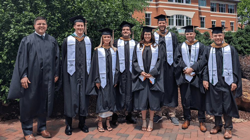 MSRE graduates and program director and senior lecturer Daniel Wright