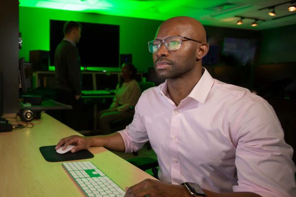 Man at computer desk; Charlotte MBA online