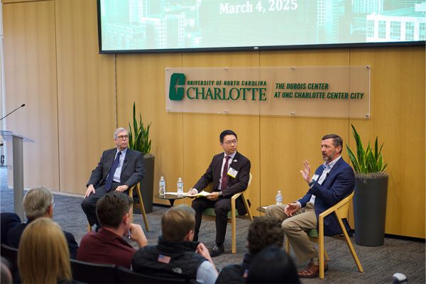 Three men, John Connaughton, Ethan Chiang, and Matt Martin, sit together in a professional panel discussion setting.