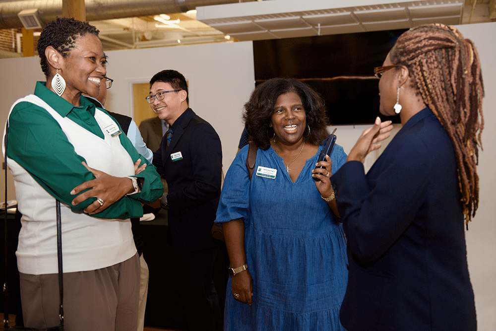 LaShana Wiggs, Kimberly Moore-Wright '95 and guest at board members/faculty meeting