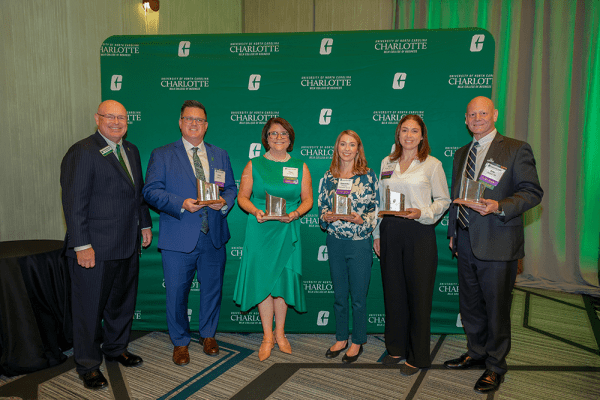 Belk College 2025 Alumni Awards recipients and Dean Richard Buttimer