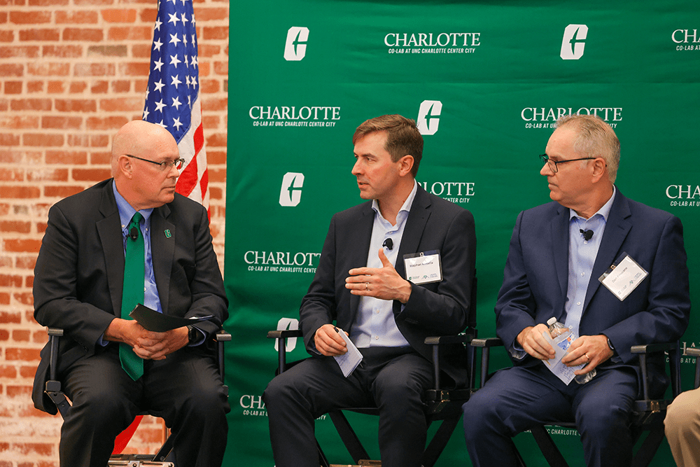 Belk College of Business Dean Richard Buttimer, Stephen Kinsella and Belk College lecturer Don Finucane