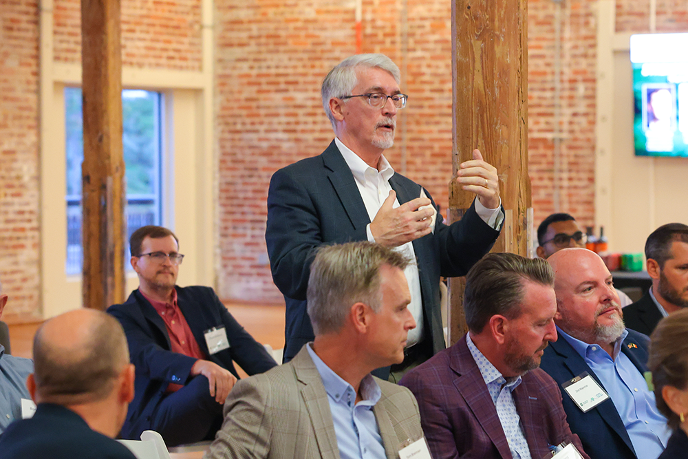 Belk College Clinical Associate Bill Sofsky asks a question of the  panelists.