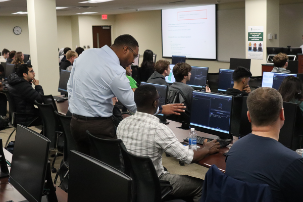 Training the Street 2026; Mentor working with UNC Charlotte students on computers